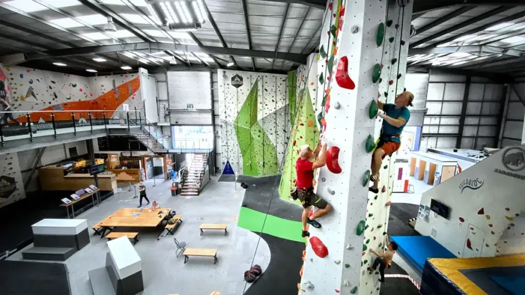 Overhead Image of Boardroom Climbing Bouldering Gym With Two People Climbing a Rock Wall Tower