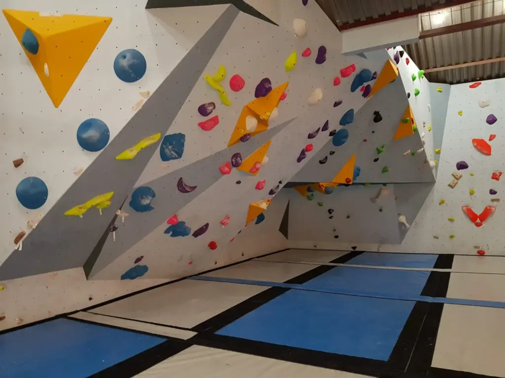 Inside of Boulder Shack Gym With Colourful Rock Climbing Wall and Blue Crash Mats