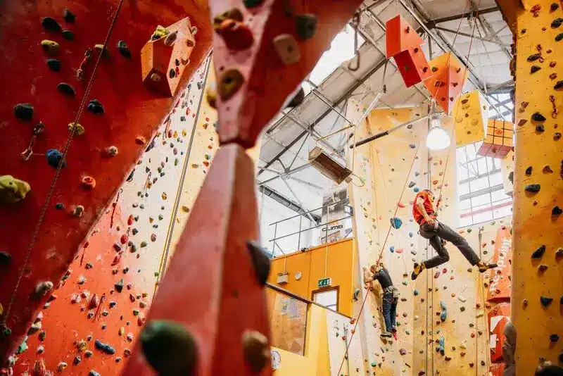 Interior of Redpoint Climbing Gym With Two People Climbing the Walls