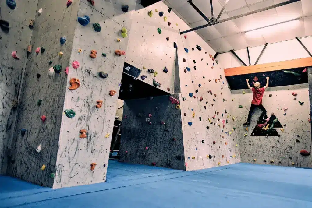 Inside of Rockburn Bridport Bouldering Gym With Someone Climbing A Section of the Wall