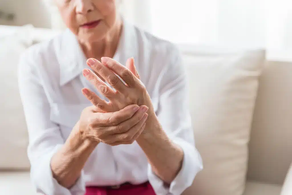 Image of an Older Woman With Arthritis Holding Her Hand Up