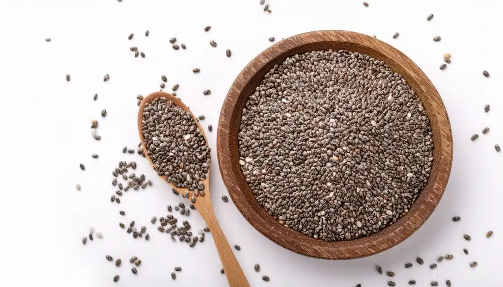 Image of a Wooden Bowl of Chia Seeds With a Wooden Spoon Beside It