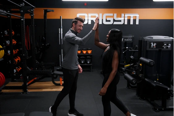OriGym tutor and student high fiving OriGym tutor and student high fiving