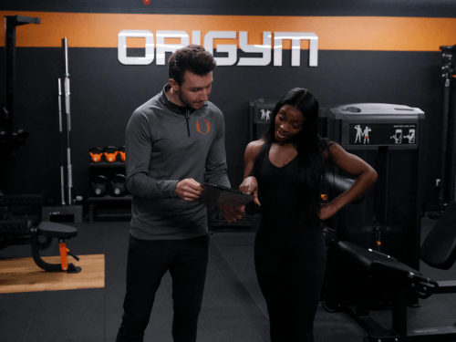 OriGym tutor giving feedback to student OriGym tutor and student in personal training workshop